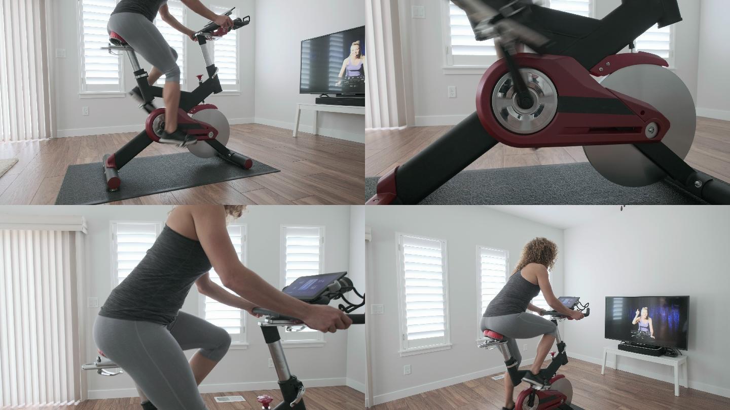 在家里骑自行车锻炼的女人