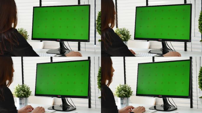 在使用绿屏电脑工作的女人