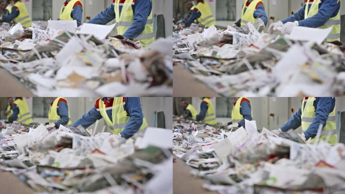 回收设施工人用手在传送带上分离垃圾
