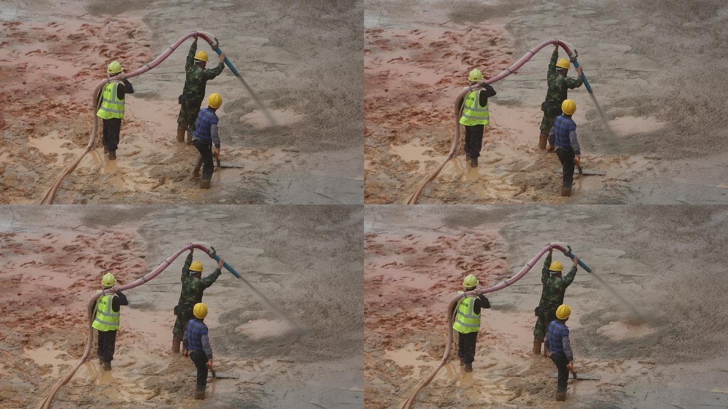 工人浇水泥铺路