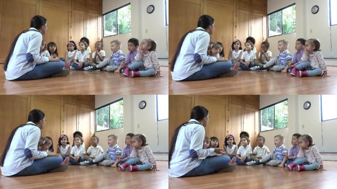 幼儿园老师坐在地板上和学生讨论