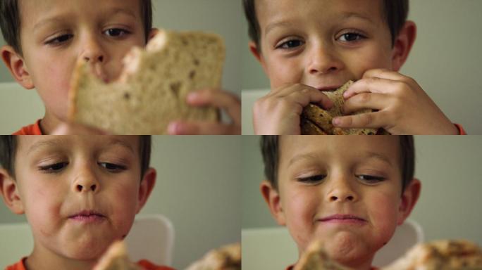 男孩咬三明治全麦面包营养早餐小孩子吃早餐