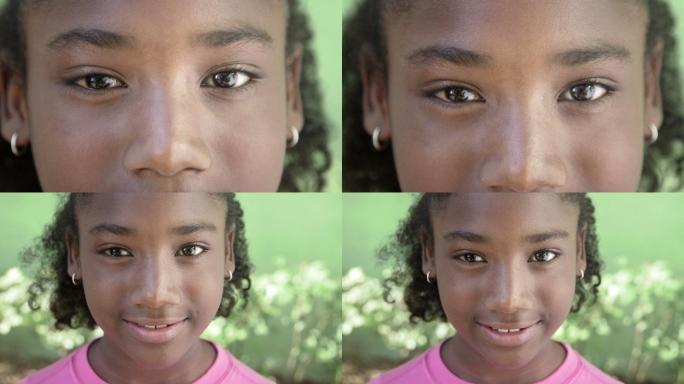 一个快乐的非洲女孩看着相机微笑的画像。