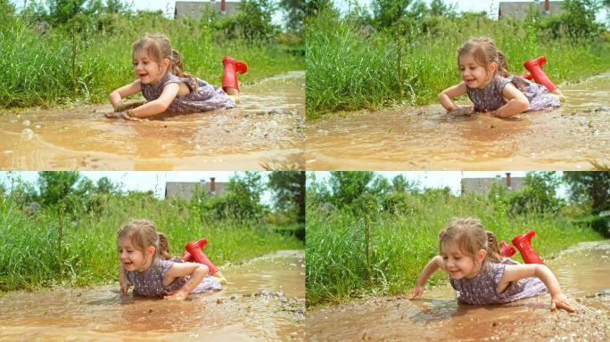 小女孩趴在水坑里，手在动，好像在游泳