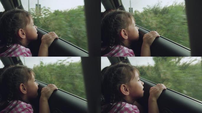 小女孩坐在车里欣赏风景