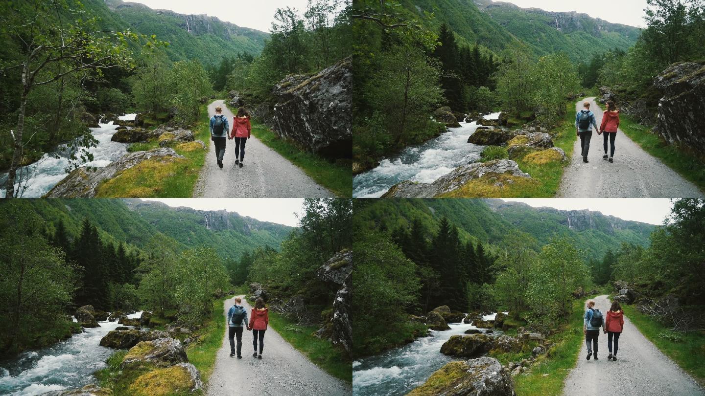 在挪威乡村散步的一对夫妇