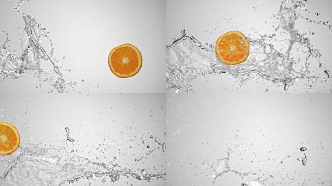 在白色背景上，一片橘子被空气中的水碰撞