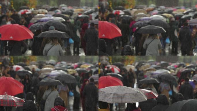 人们打着雨伞在繁忙的商业街上行走