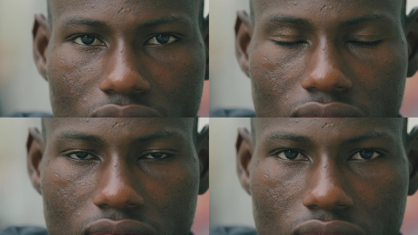 沉思悲伤的黑人年轻人盯着相机-微距