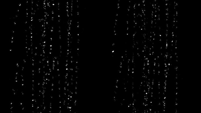 雨滴在一个黑色的背景上的慢镜头
