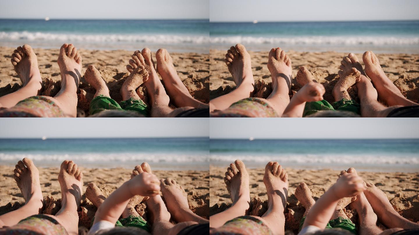 躺在海滩上的家人脚部特写