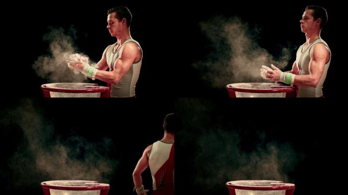 体操运动员用粉笔在碗边画他被包裹的手
