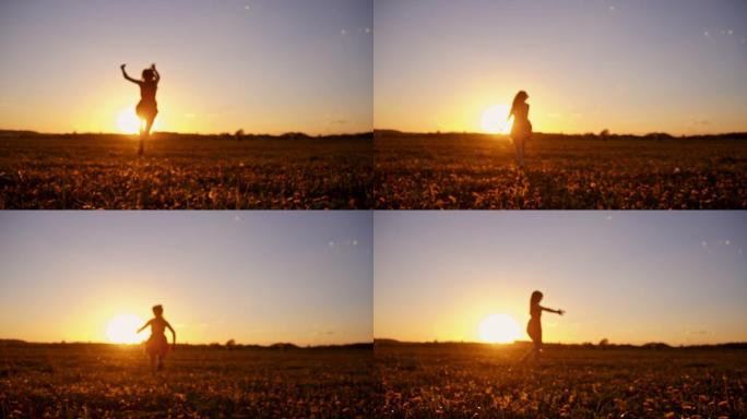 落日时分，快乐的女孩在草地上奔跑