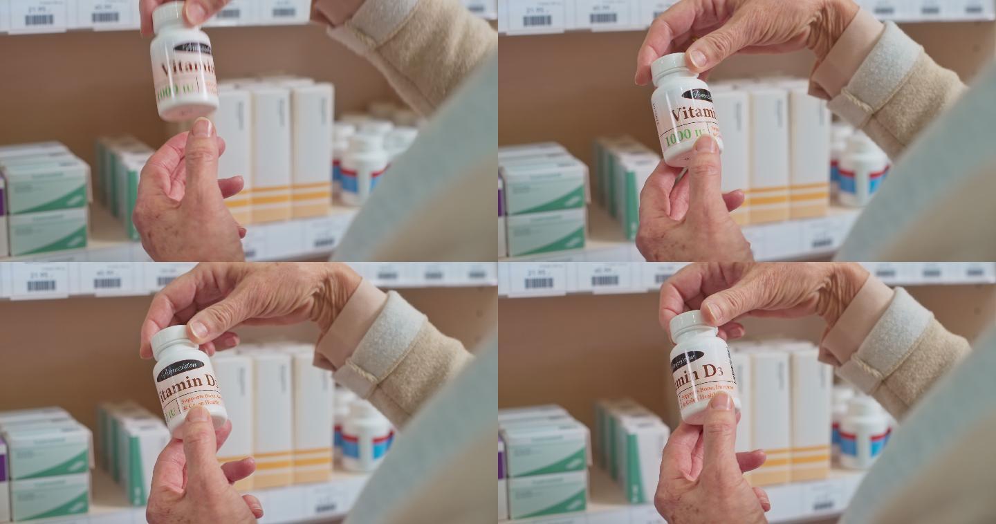 一个妇女的手拿着一瓶维生素在药店