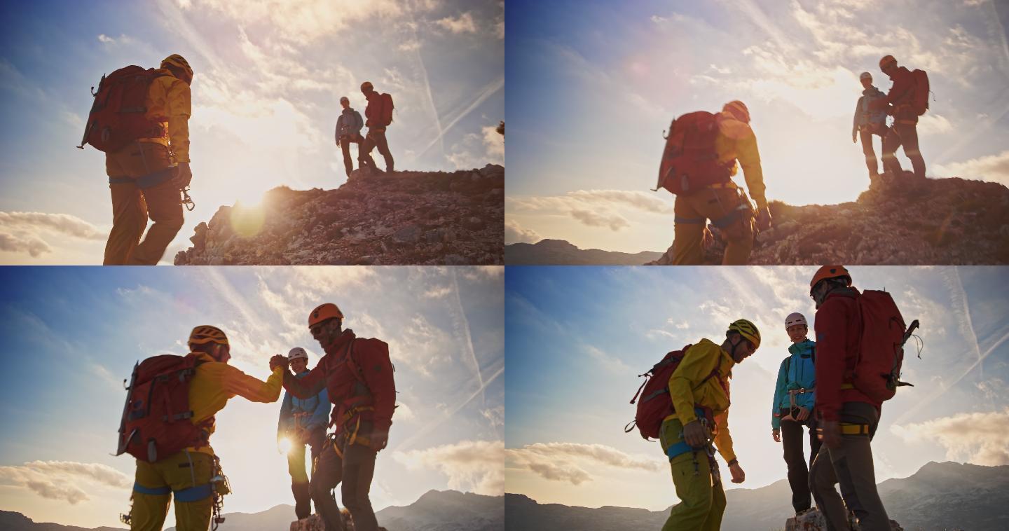 登山者在阳光下与等待在山顶的登山者握手