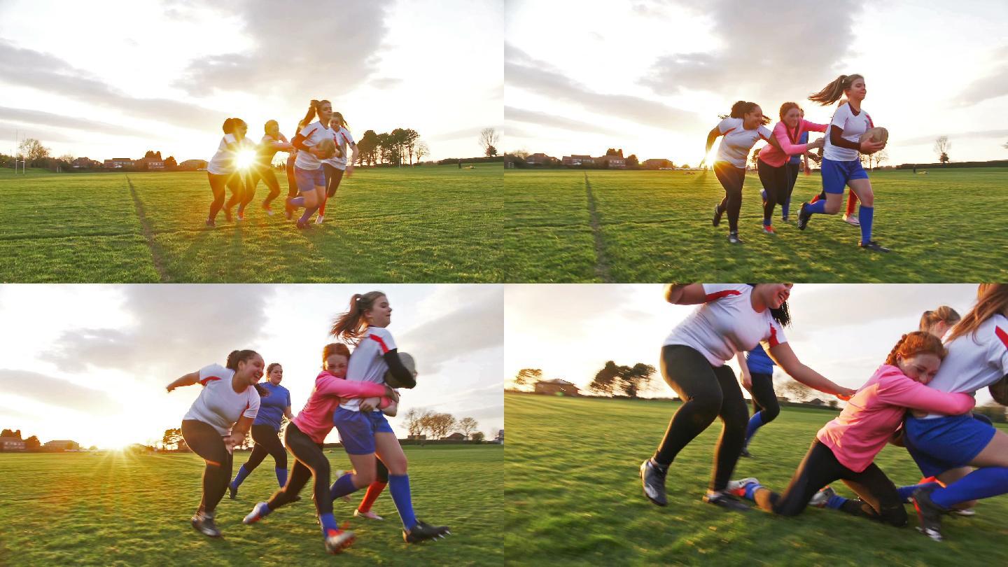 十几岁的女孩在球场上打橄榄球