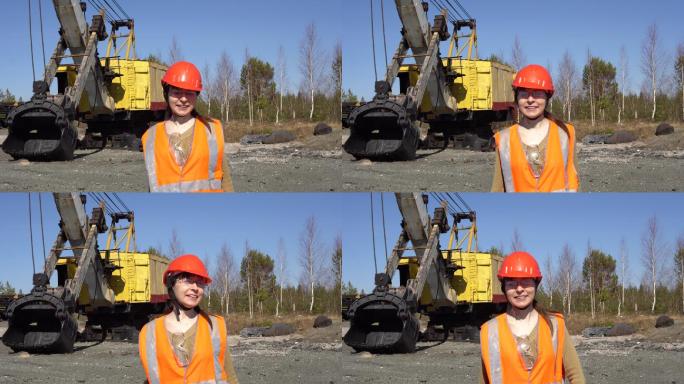 女工人站在一台挖土机旁跳舞