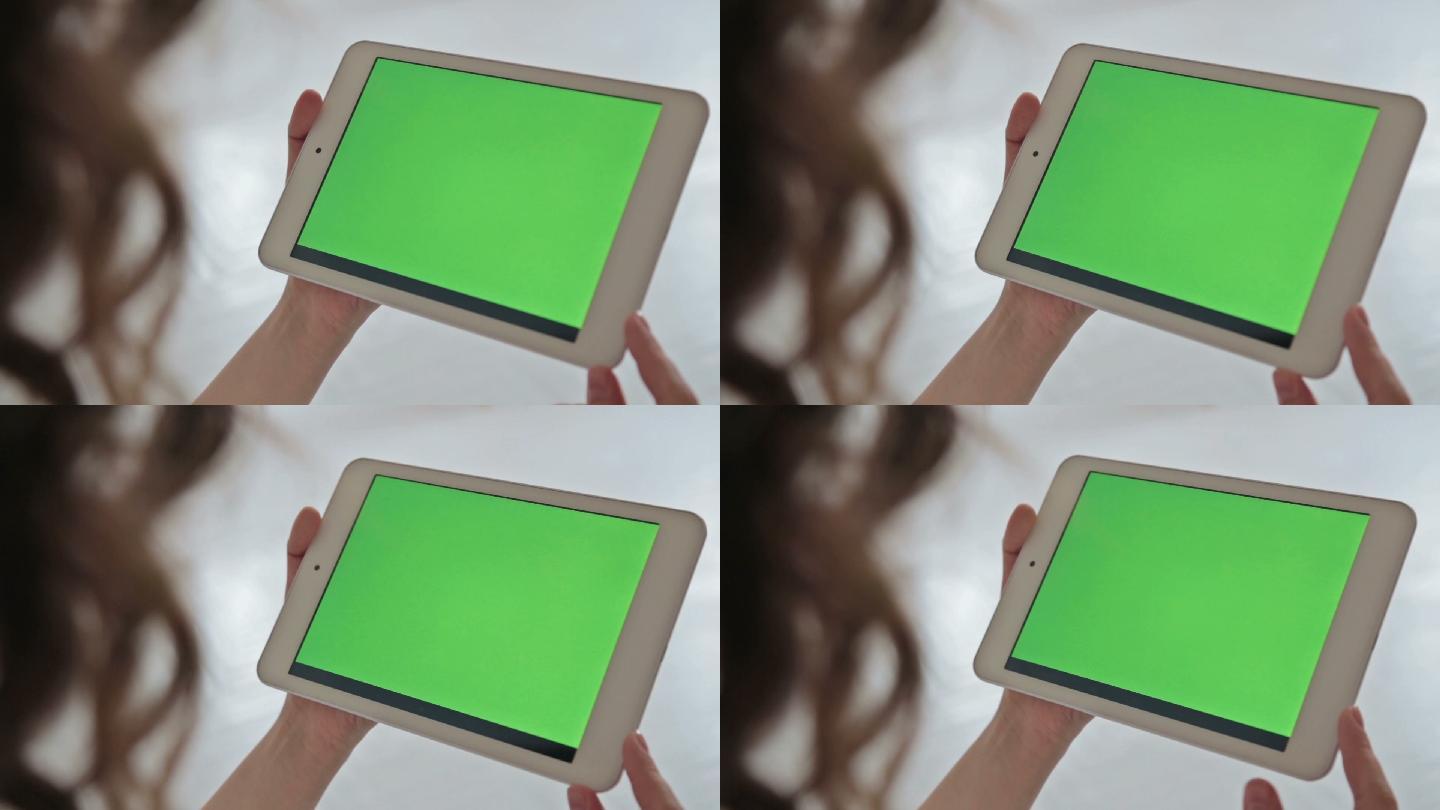 在家使用电子平板电脑的女人，绿屏