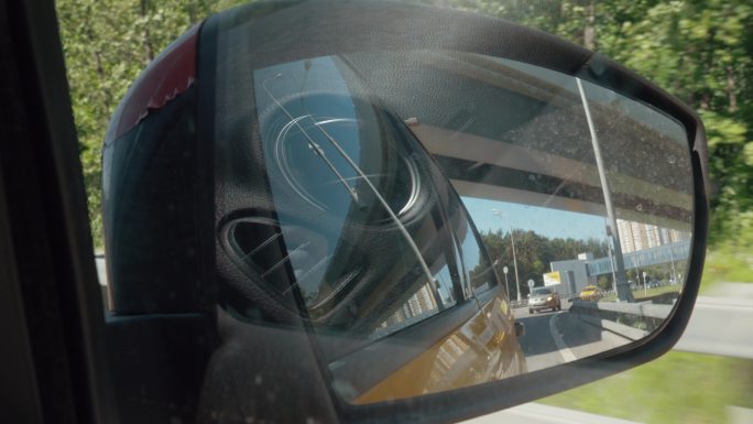 汽车侧镜反射下的城市交通景观