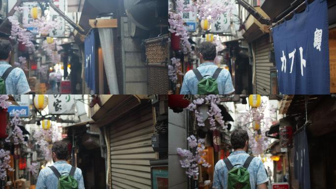游客在东京烟雾弥漫的小巷中行走的后视图