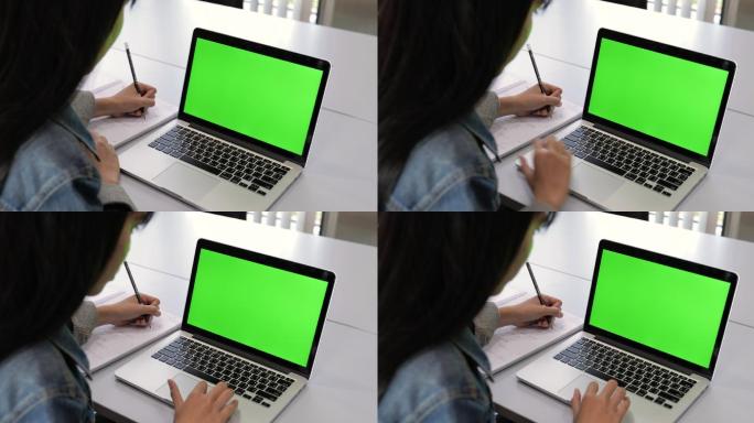 大学生看绿屏笔记本电脑