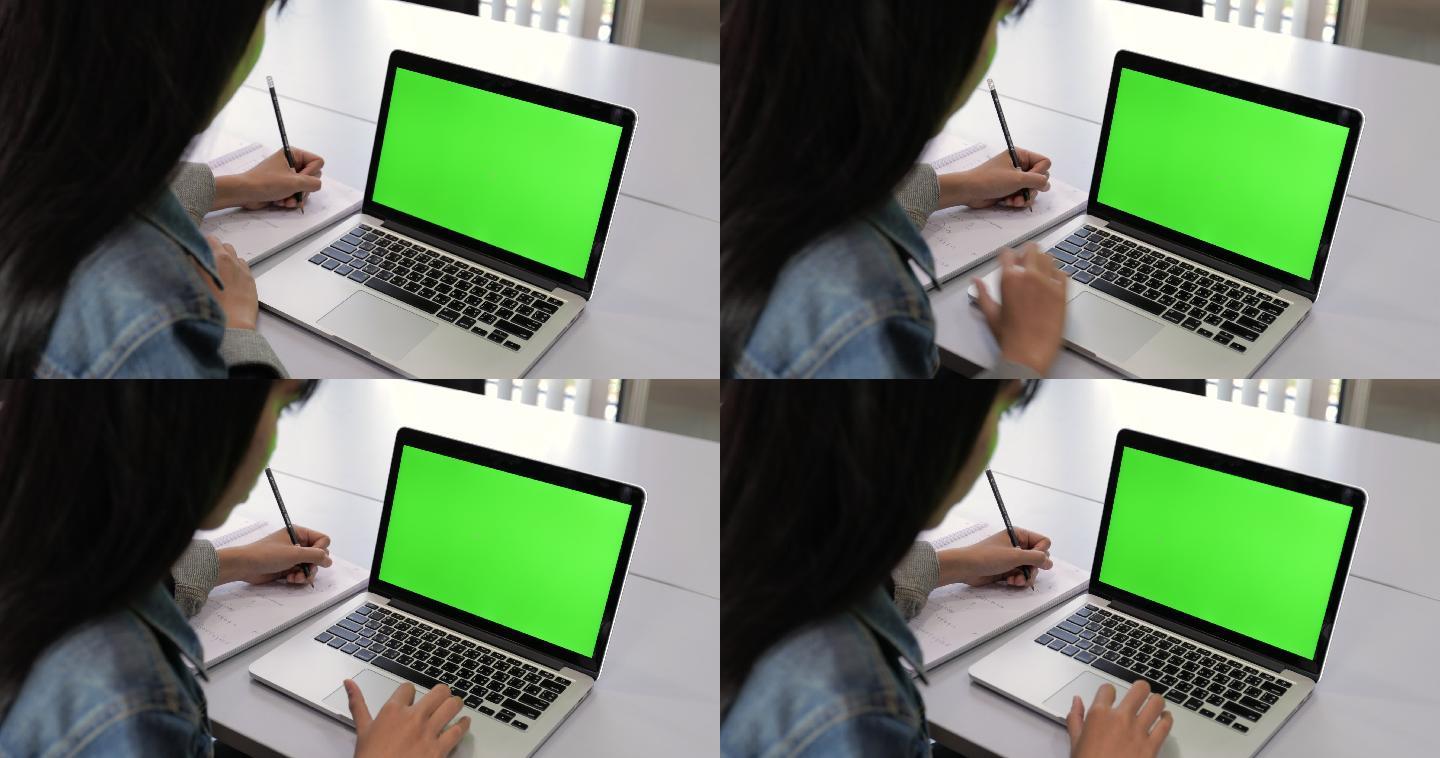 大学生看绿屏笔记本电脑