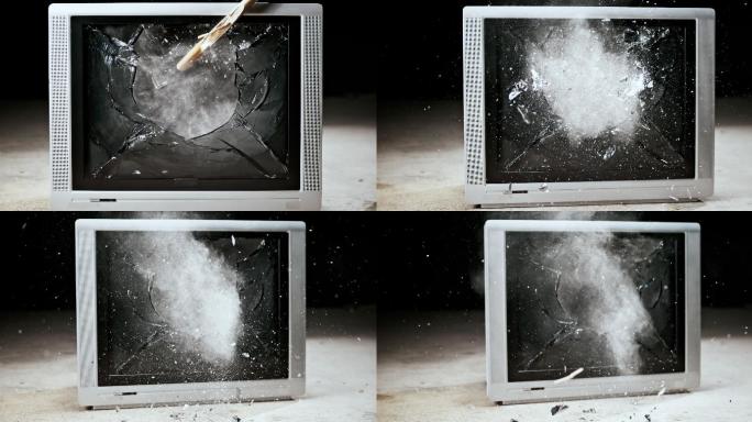 用锤子砸碎了一台旧电视机的屏幕