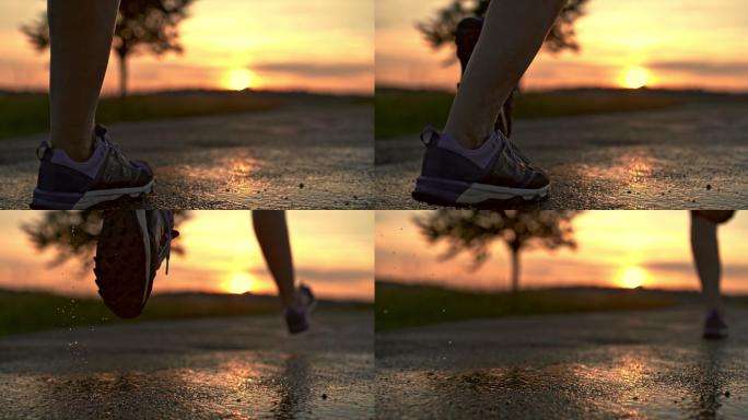 跑步者奔跑在湿的沥青公路上