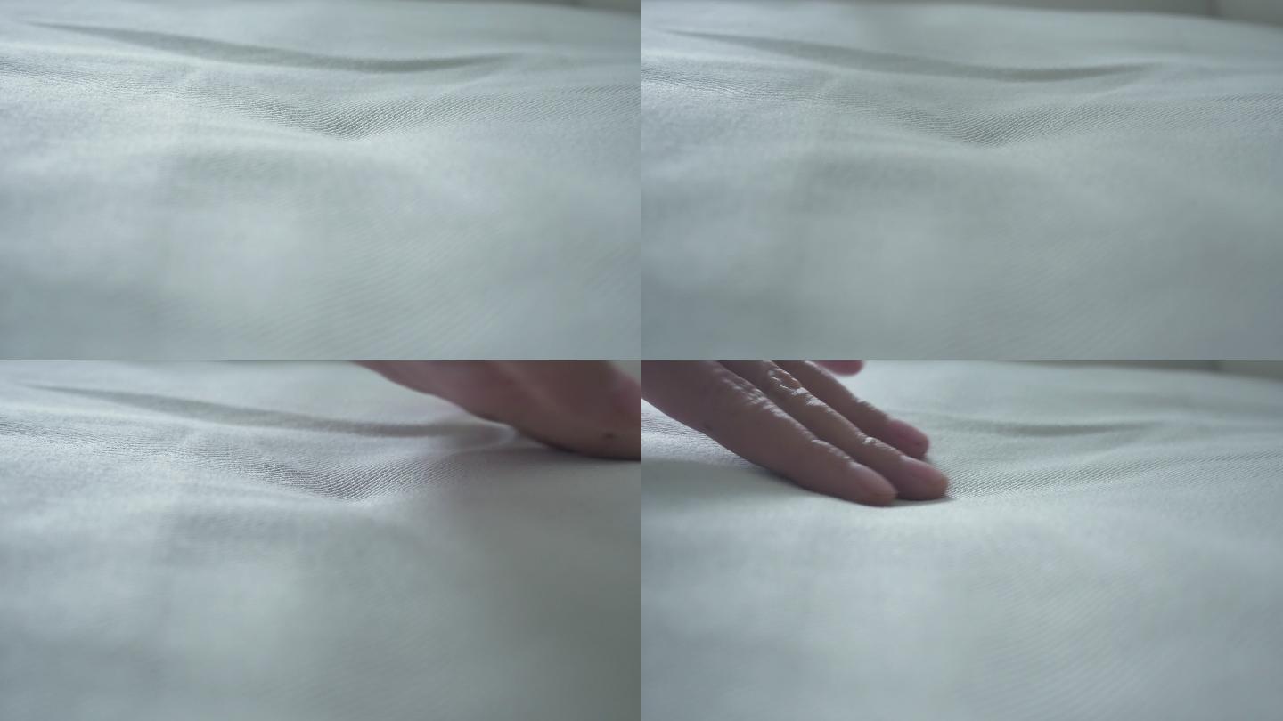 手抚摸着柔软干净的床单。