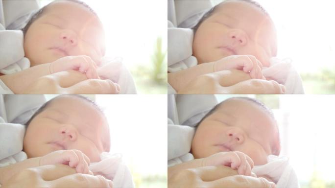 特写镜头父母的手抱着新生儿，婴儿