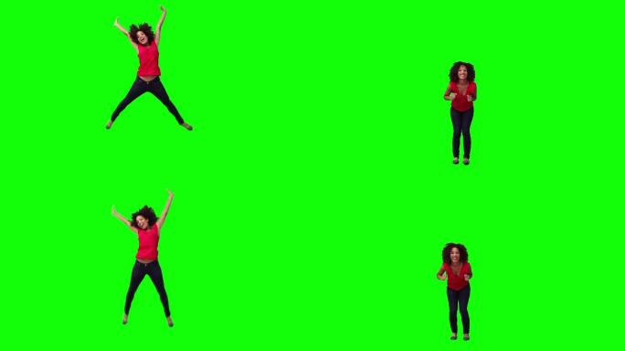 一个快乐的女人在绿色背景前跳跃
