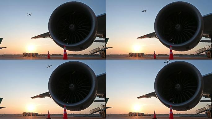 夕阳下停在机场的飞机的涡轮发动机