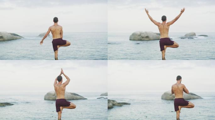 一个男子在海滩上练习瑜伽