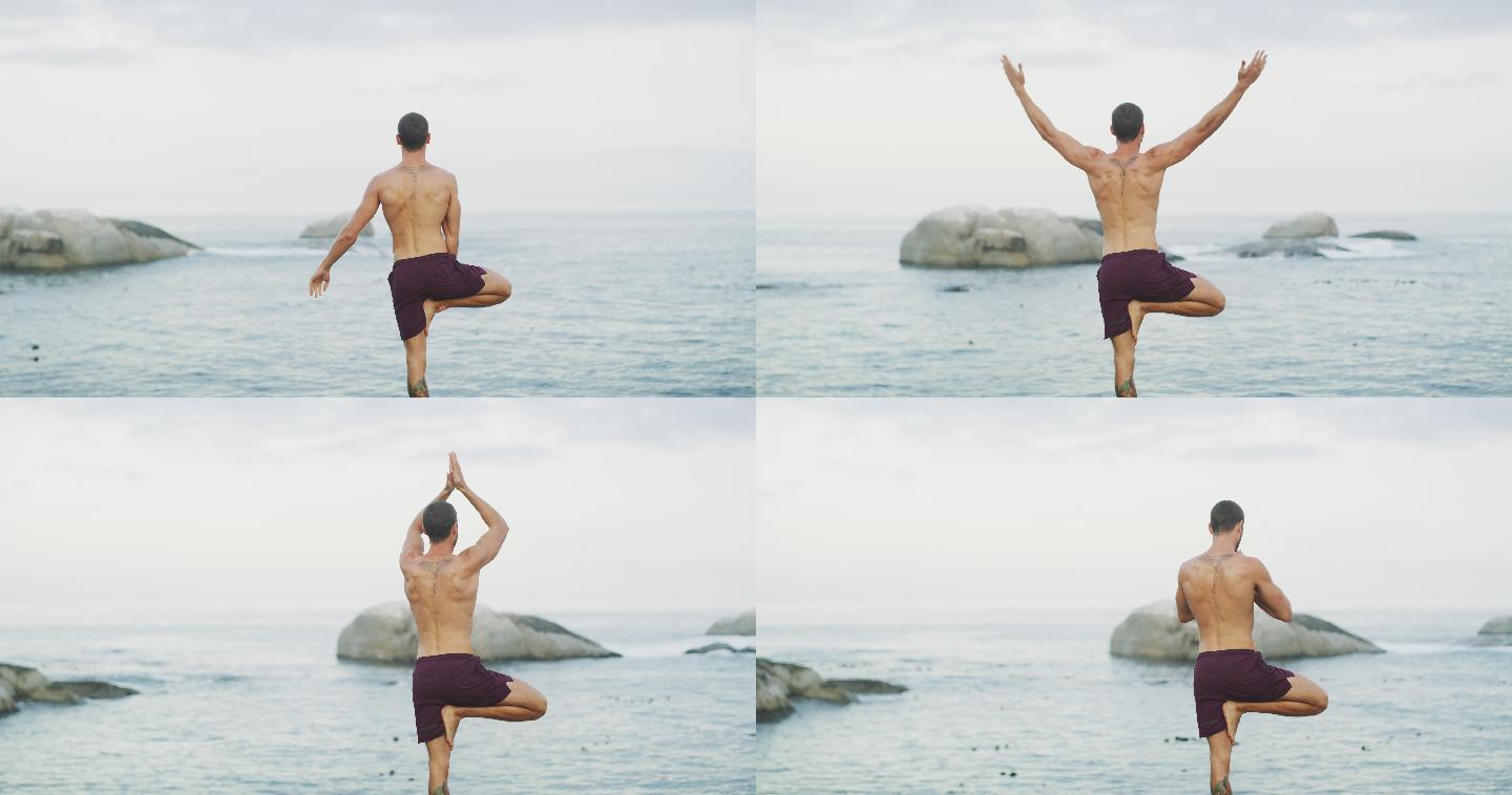 一个男子在海滩上练习瑜伽