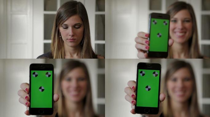 年轻女子将智能手机在镜头前展示