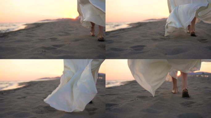 走在沙滩上的女人细沙风吹白裙美女光脚行走