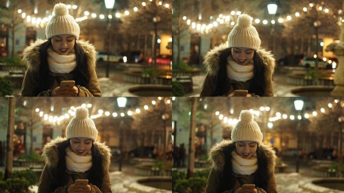 女子在圣诞夜的街头玩手机