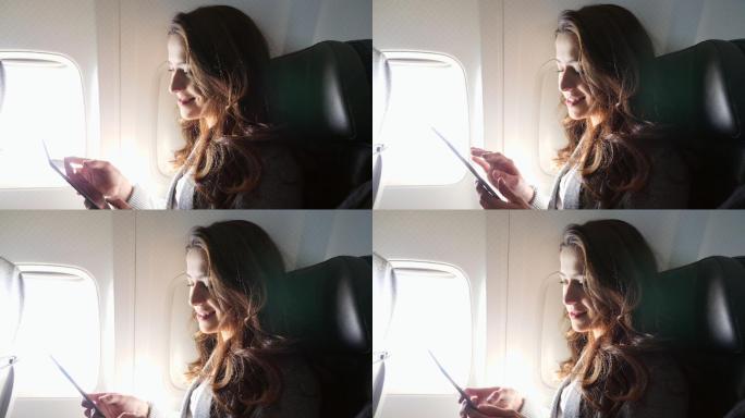 微笑的年轻女子在飞行中使用智能手机