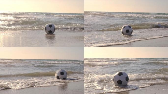海浪拍打在沙滩上的足球