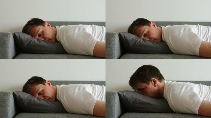 沮丧的男人睡在枕头上翻身的画像
