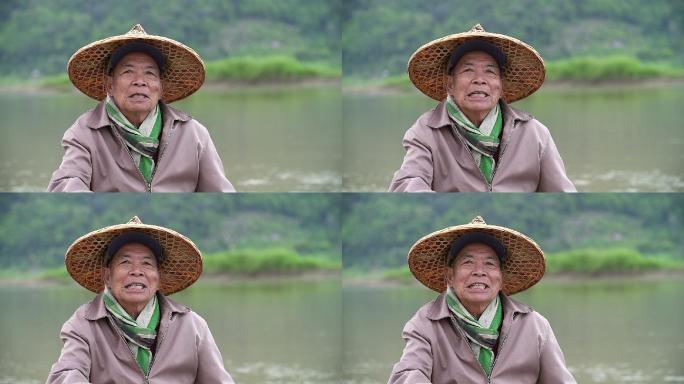 快乐的老渔夫笑脸坐在河边的画像。
