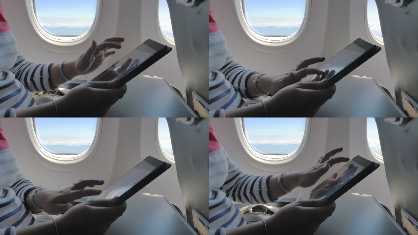 在飞机上使用数字平板电脑的手