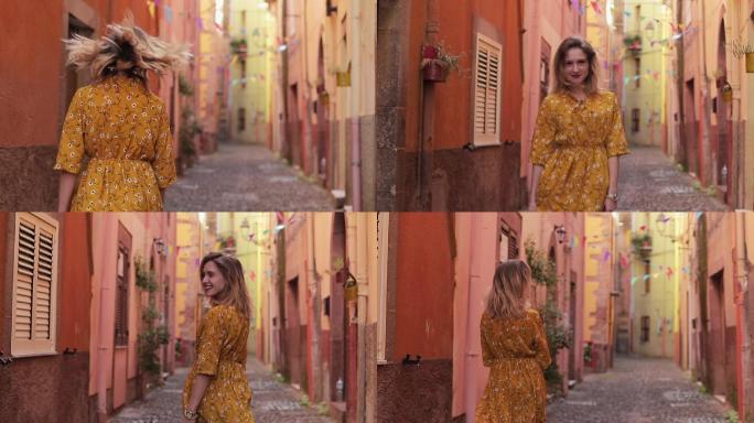 一个美丽的女孩走过意大利古城的街道。