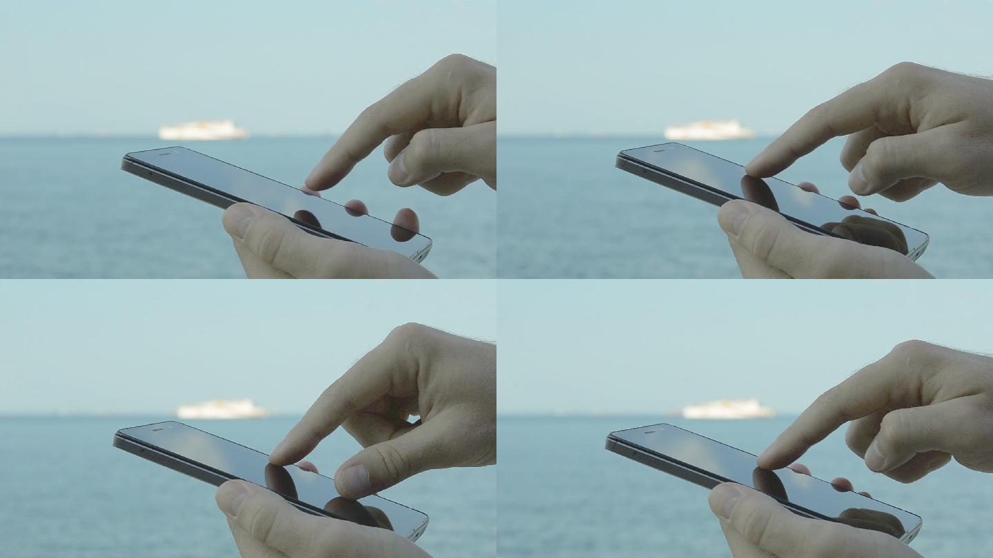 在海边玩手机的人