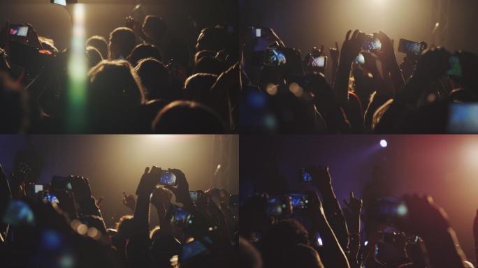 人们在音乐会上用智能手机拍摄和拍照