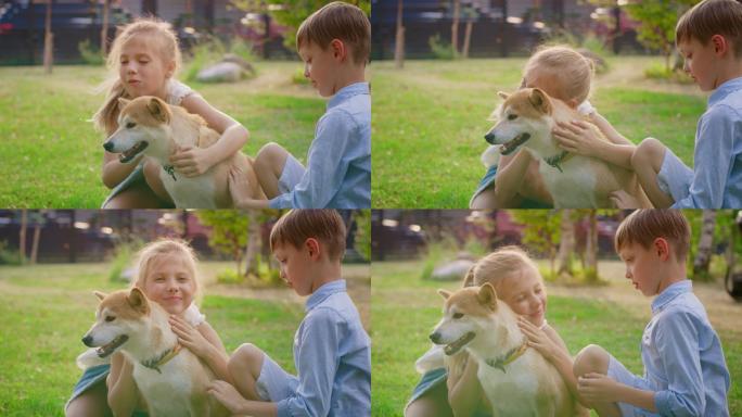 小男孩和小女孩在院子里与狗狗玩耍