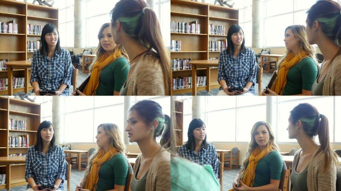 年轻的女教师在图书馆与学生交谈