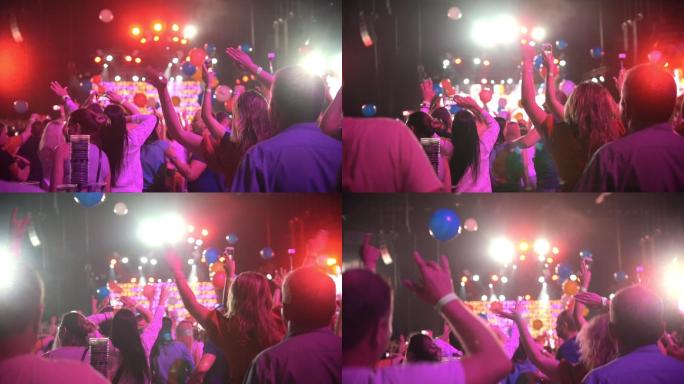 一群人在音乐会上举手跳舞