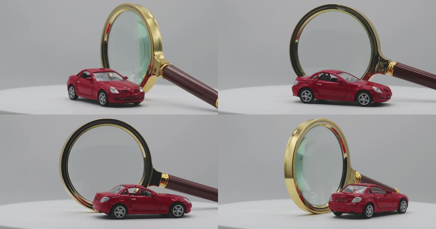 一辆红色小汽车在放大镜前旋转