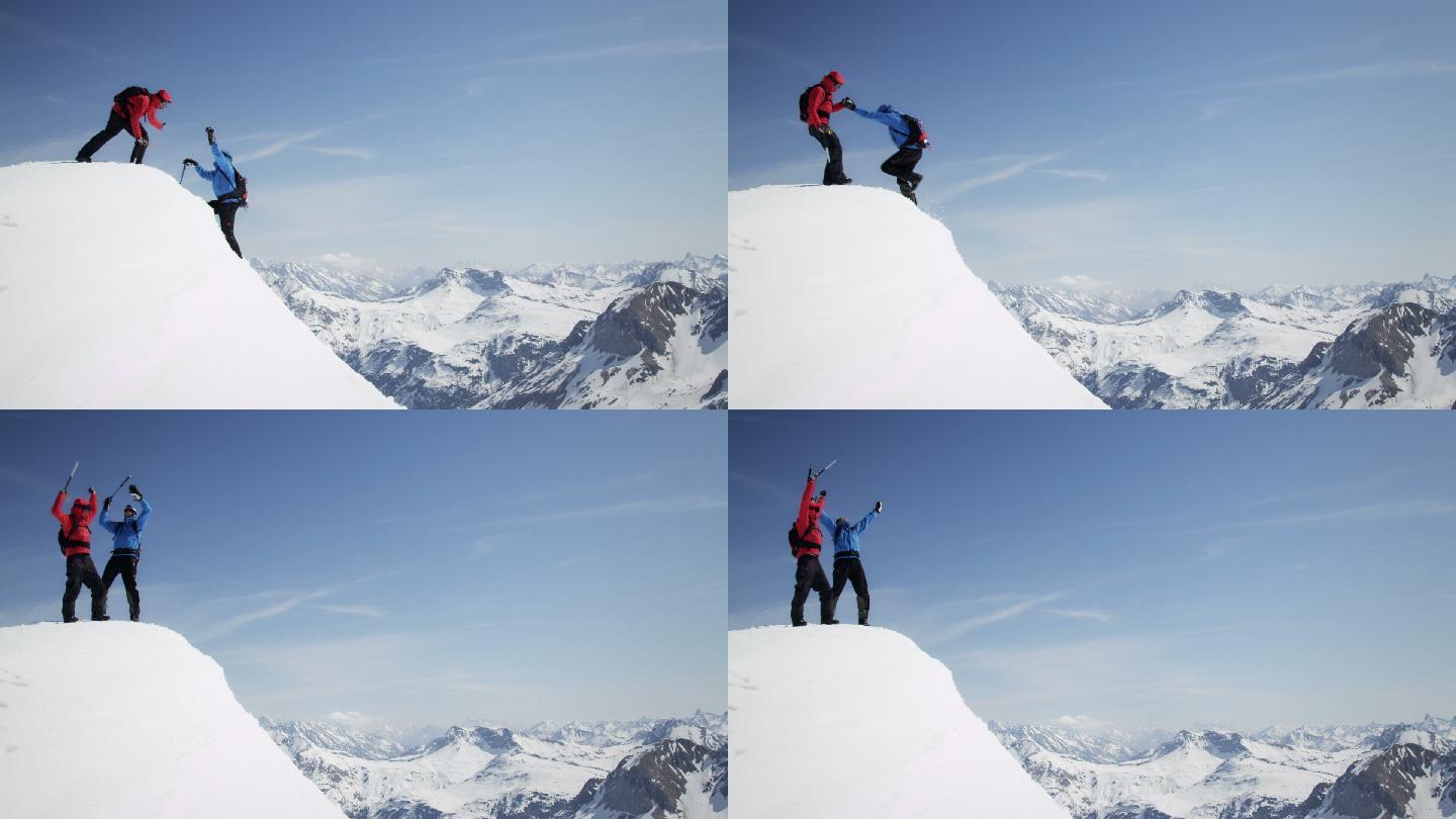 登山者互相帮助到达白雪覆盖的山峰